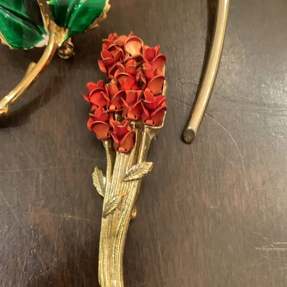 Three vintage rose brooches
